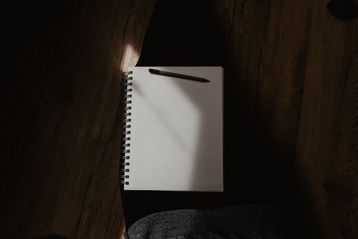 White spiral notebook on black textile