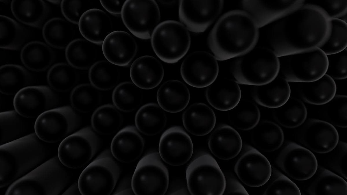 Close-up of many dark cylindrical objects