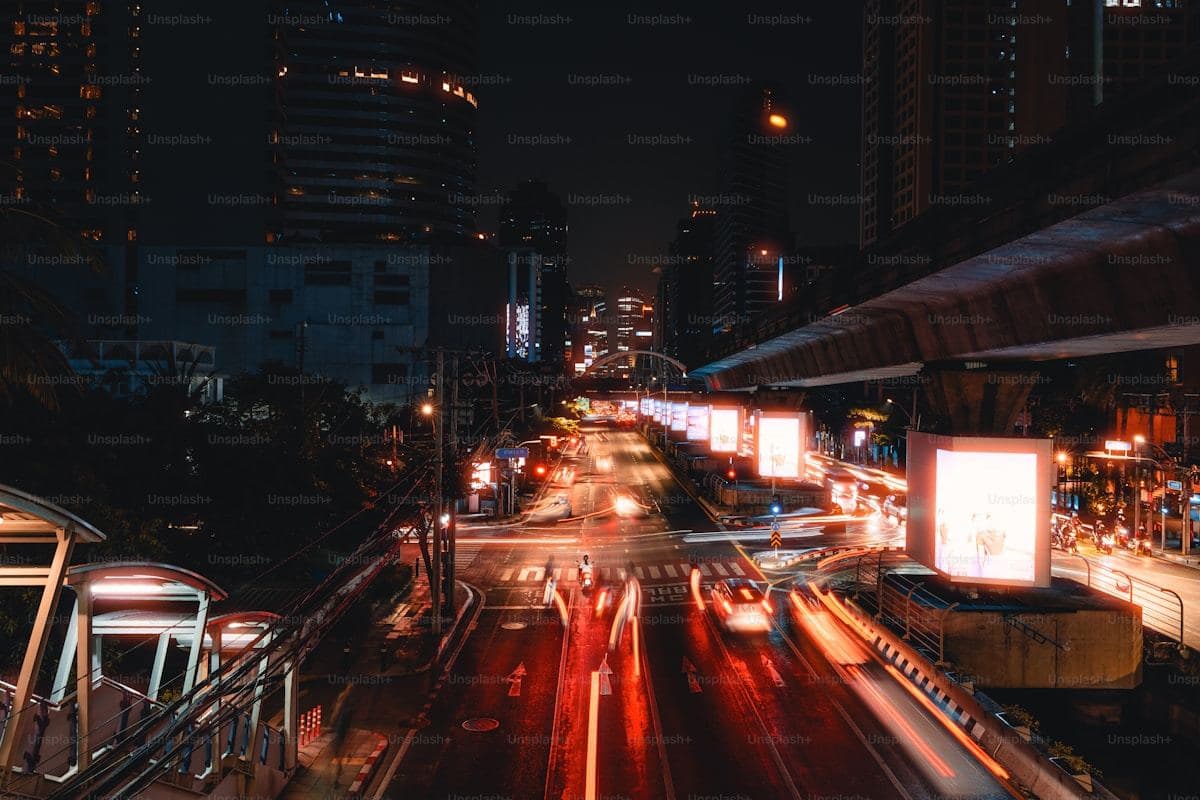 City lights illuminate a bustling night street scene