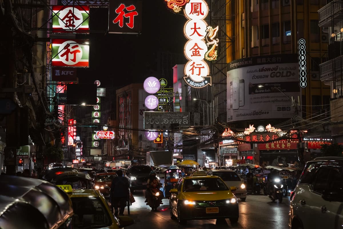 Bangkok street alive with neon signs at night